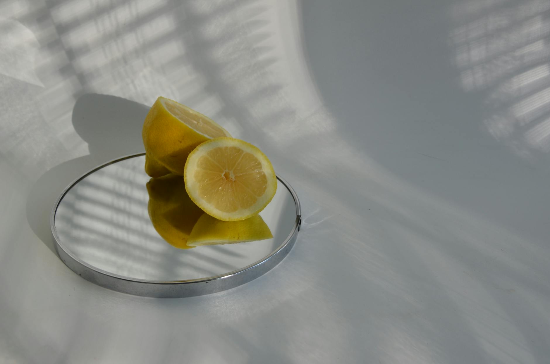 Two fresh lemons held in cupped hands, symbolizing gentle care and reconnection with pleasure.