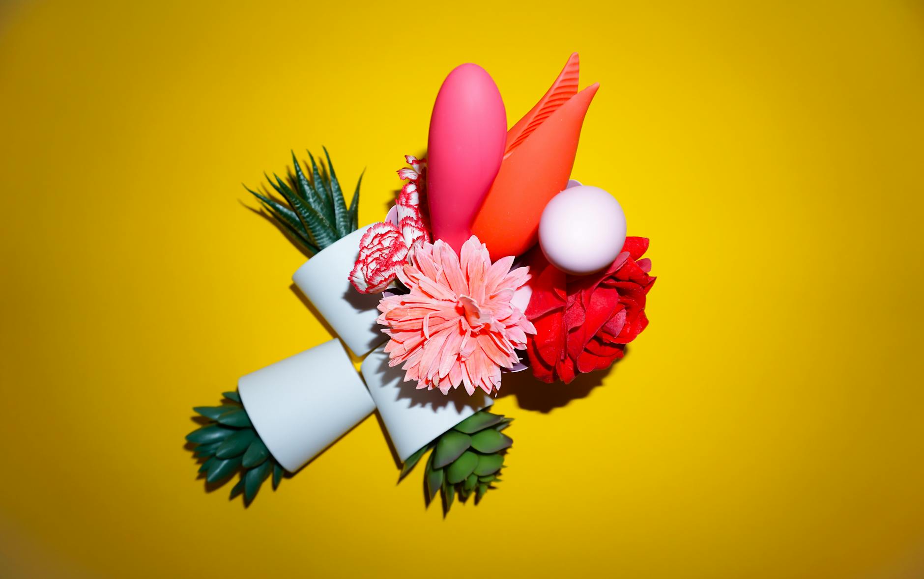 A hand holding an orange vibrator against a minimalistic purple backdrop, showcasing modern sensuality during recovery.