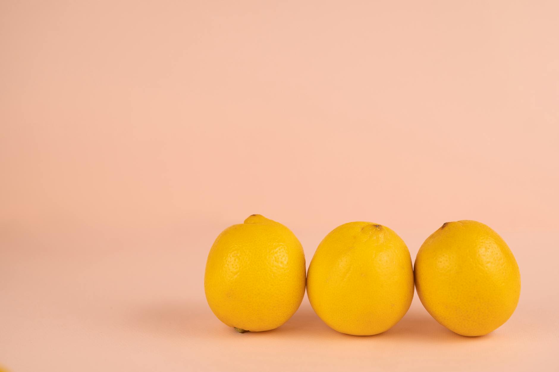 Bright ripe lemons arranged on a pastel background, symbolizing fresh exploration and citrus-bright pleasure