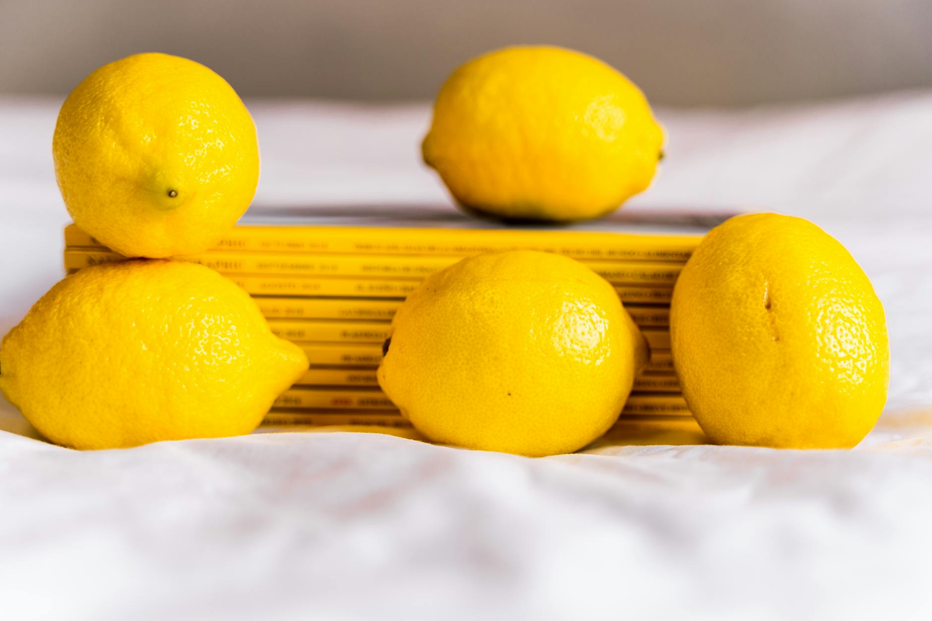 Fresh yellow lemons arranged with books, symbolizing natural variation and self-care
